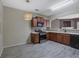 Well-lit kitchen featuring updated cabinets, countertops, and black appliances at 55 Burns View Ct, Lawrenceville, GA 30044