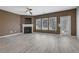 A spacious living room featuring a fireplace, large windows, neutral paint colors and contemporary flooring at 55 Burns View Ct, Lawrenceville, GA 30044