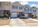 Charming townhome featuring a one car garage, stone accents, and inviting curb appeal at 55 Burns View Ct, Lawrenceville, GA 30044