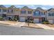 Street view of attractive townhouses featuring one-car garages and colorful exterior design at 55 Burns View Ct, Lawrenceville, GA 30044