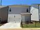 Exterior view of the home's garage and driveway at 140 Birch Tree Way, Cumming, GA 30040