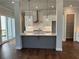 Modern kitchen with white cabinets, quartz countertops, and island at 140 Birch Tree Way, Cumming, GA 30040