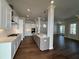 Open concept kitchen with white cabinets and stainless steel appliances at 140 Birch Tree Way, Cumming, GA 30040