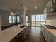 Modern kitchen with island, stainless steel appliances, and sliding door access at 140 Birch Tree Way, Cumming, GA 30040