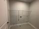 Laundry room with shelving and vinyl flooring at 140 Birch Tree Way, Cumming, GA 30040