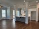 Open concept living area with hardwood floors and kitchen view at 140 Birch Tree Way, Cumming, GA 30040