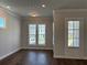 Bright living room with hardwood floors and multiple windows at 140 Birch Tree Way, Cumming, GA 30040