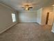 Main bedroom with carpet, ceiling fan, and window at 140 Birch Tree Way, Cumming, GA 30040