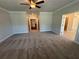 Main bedroom with carpet, ceiling fan and access to hall at 140 Birch Tree Way, Cumming, GA 30040