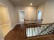 Upstairs hallway with access to bedrooms and laundry at 140 Birch Tree Way, Cumming, GA 30040