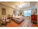 Comfortable bedroom with vintage decor, rocking chair and large window at 2240 Palmour Ct, Atlanta, GA 30337
