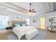 Bright bedroom featuring neutral walls, tray ceilings, ceiling fan and ensuite bathroom at 2240 Palmour Ct, Atlanta, GA 30337