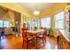 Bright dining area with wood floors, a rustic wood table, and natural light, adjacent to a living area at 2240 Palmour Ct, Atlanta, GA 30337