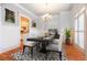 Elegant dining room with a modern chandelier, wainscoting and windows with natural light at 2240 Palmour Ct, Atlanta, GA 30337