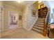 Inviting hallway features a staircase to the second floor with hardwood and carpet steps at 2240 Palmour Ct, Atlanta, GA 30337