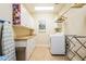 Laundry room featuring white cabinets, washer, dryer and ironing board at 2240 Palmour Ct, Atlanta, GA 30337