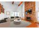 Bright living room with a stone fireplace, wood floors, comfortable seating and high ceilings at 2240 Palmour Ct, Atlanta, GA 30337