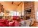 Open living room with a stone fireplace, wood floors, comfortable seating and lots of light at 2240 Palmour Ct, Atlanta, GA 30337