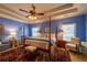 Serene main bedroom with tray ceiling, a four-poster bed, and a decorative area rug at 2240 Palmour Ct, Atlanta, GA 30337