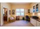 Comfortable office with custom built-ins, a cozy chair, and a view of the outside plus adjacent bathroom at 2240 Palmour Ct, Atlanta, GA 30337