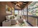 Inviting screened porch with wicker furniture, floral rug and wooded views. Perfect for relaxation at 2240 Palmour Ct, Atlanta, GA 30337