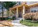 Stone-accented porch and landscaped front yard create a welcoming entrance to this elegant home at 2240 Palmour Ct, Atlanta, GA 30337