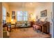 Cozy living room with piano, floral sofa, and natural light at 2240 Palmour Ct, College Park, GA 30337