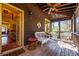 Cozy screened porch with wicker furniture, ceiling fan, and inviting entryway at 2240 Palmour Ct, Atlanta, GA 30337