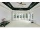 Large flex room with custom ceiling design, ample natural light, and plush neutral carpeting at 110 Robinwood Ct, Fayetteville, GA 30214