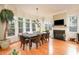 Sunlit breakfast nook featuring a cozy fireplace and large windows at 110 Robinwood Ct, Fayetteville, GA 30214