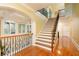 Grand staircase with hardwood floors and ornate wrought iron railings, connecting multiple levels of the home at 110 Robinwood Ct, Fayetteville, GA 30214