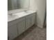 Bathroom featuring tile flooring, double sinks, white cabinets, and granite countertops at 266 Broder Farms Dr, Stockbridge, GA 30281