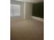 Carpeted bedroom featuring a window with light-filtering blinds and an accent wall at 266 Broder Farms Dr, Stockbridge, GA 30281