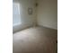 Bedroom featuring neutral carpet, a window with blinds, and minimal decor at 266 Broder Farms Dr, Stockbridge, GA 30281