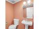 Updated powder room with pedestal sink and peach walls at 2769 Peachtree Ne Rd # 10, Atlanta, GA 30305