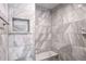 Large walk-in shower with marble style tile and built-in bench seat at 2769 Peachtree Ne Rd # 10, Atlanta, GA 30305