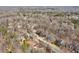 Aerial view highlighting home's setting in a quiet, tree-lined neighborhood at 4035 Powerscourt Pl, Suwanee, GA 30024