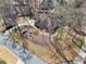 Aerial view of house and surrounding wooded area at 4035 Powerscourt Pl, Suwanee, GA 30024