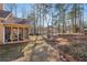 Spacious backyard with mature trees and a view of neighboring homes at 4035 Powerscourt Pl, Suwanee, GA 30024