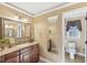 Bathroom with granite vanity, large mirror, and shower at 4035 Powerscourt Pl, Suwanee, GA 30024