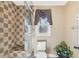 Bathroom with checkered tile shower and toilet at 4035 Powerscourt Pl, Suwanee, GA 30024