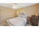 Bright bedroom with ceiling fan and dresser at 4035 Powerscourt Pl, Suwanee, GA 30024