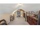 Bonus room with sloped ceiling, glass-top table, and bookcase at 4035 Powerscourt Pl, Suwanee, GA 30024