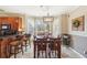 Bright breakfast nook with wood table and chairs, and large window overlooking backyard at 4035 Powerscourt Pl, Suwanee, GA 30024