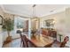 Spacious dining room featuring a large table, hardwood floors, and elegant chandelier at 4035 Powerscourt Pl, Suwanee, GA 30024