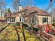 Exterior view of a two-story home with a screened porch and yard at 4035 Powerscourt Pl, Suwanee, GA 30024