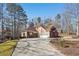 Red brick house with a side view showcasing a two-car garage at 4035 Powerscourt Pl, Suwanee, GA 30024