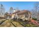 Back of house with screened porch, deck, and landscaped yard at 4035 Powerscourt Pl, Suwanee, GA 30024