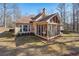 House exterior showcasing a screened porch and landscaped yard at 4035 Powerscourt Pl, Suwanee, GA 30024