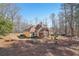 House back exterior with a screened porch and large backyard at 4035 Powerscourt Pl, Suwanee, GA 30024